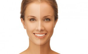 beauty and health concept - beautiful woman with half face tanned
