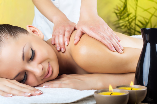 Beautiful woman getting a massage in the spa salon